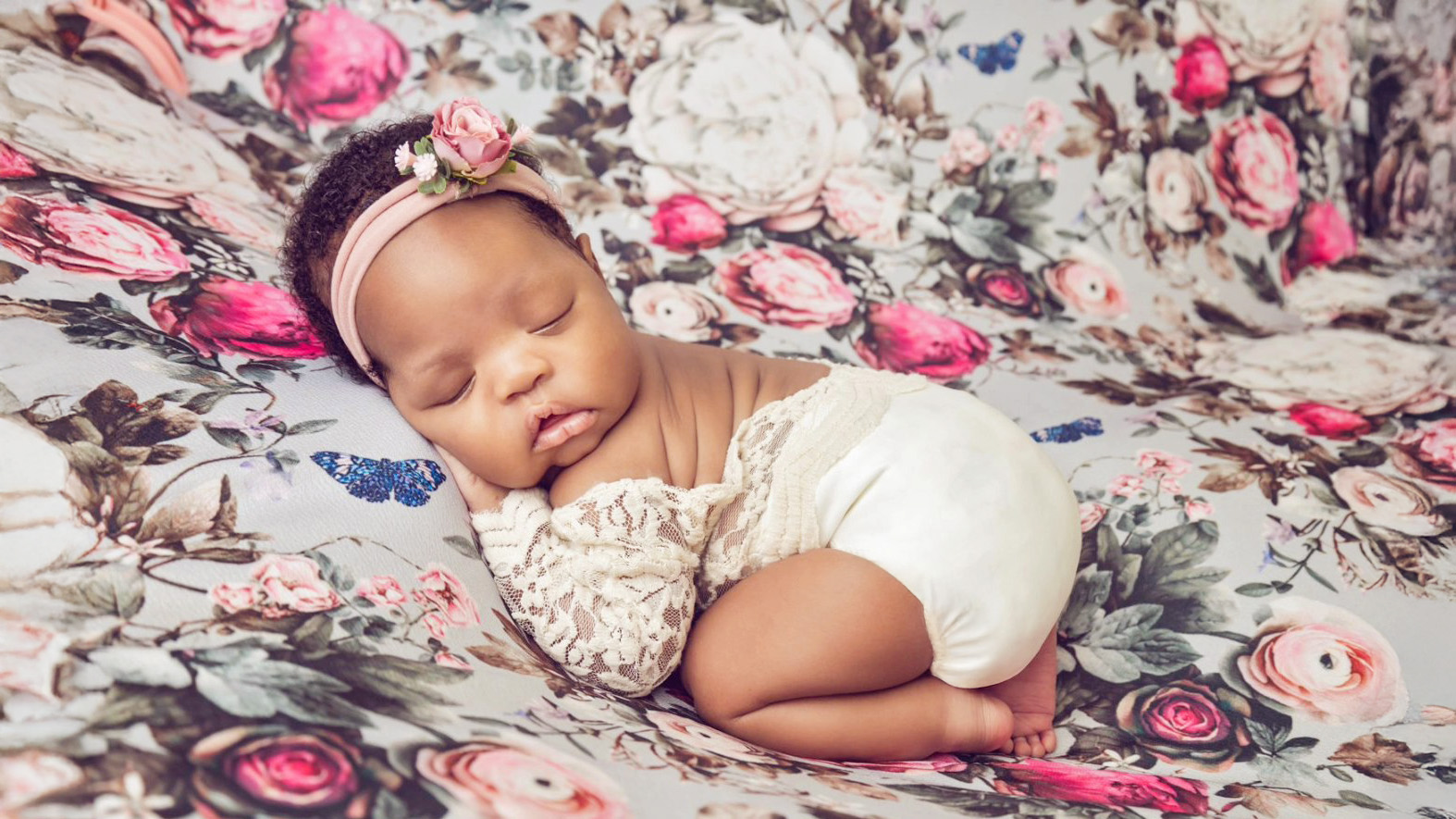 newborn baby girl bum up pose floral backdrop