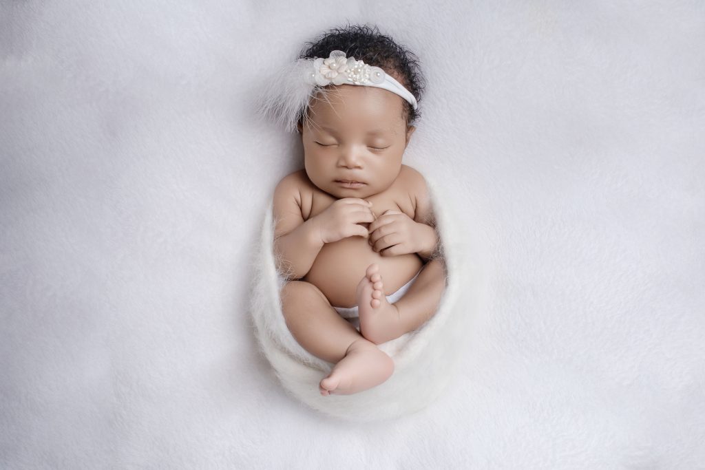 When Is the Best Time for a Newborn Photoshoot in Durban (And What If You Miss It?) Newborn baby girl on a white background