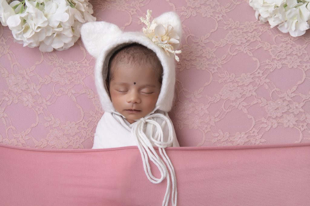 When Is the Best Time for a Newborn Photoshoot in Durban (And What If You Miss It?) Newborn baby girl with a bear bonnet