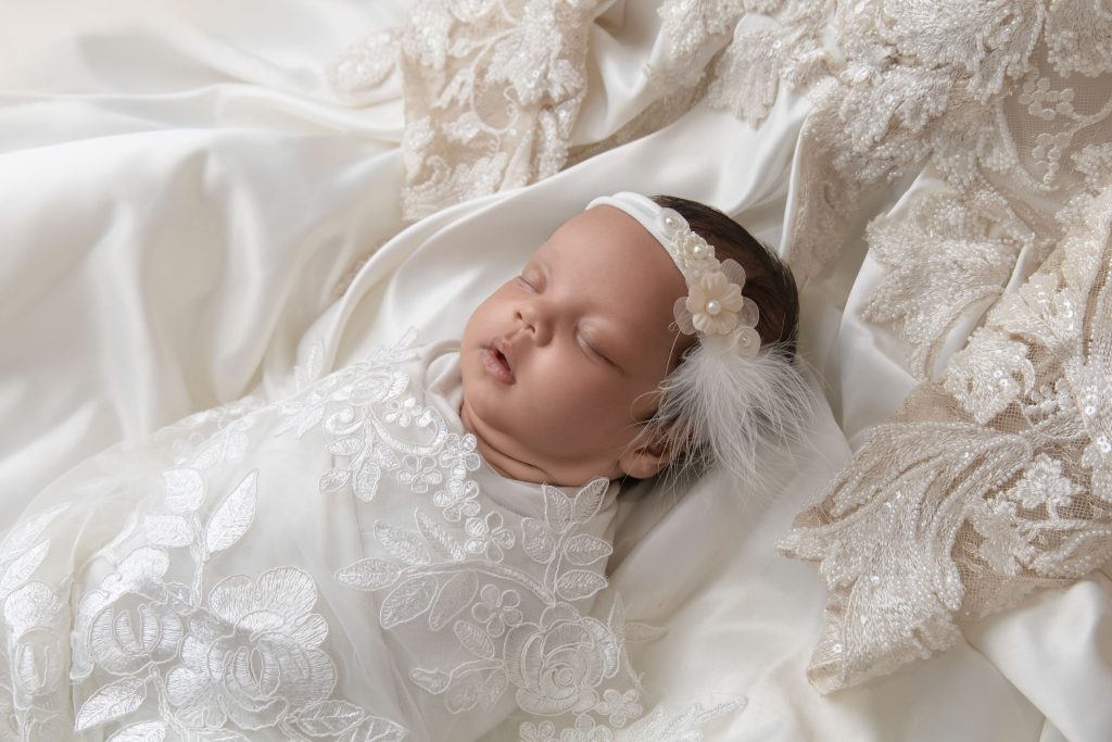 Swaddled baby in mom
